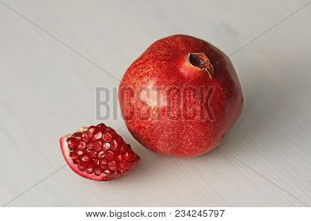 Big Ripe Red Granets Or Garnets. Fruits Of Red Ripe Pomegranate On The White Background. Vegetarian 