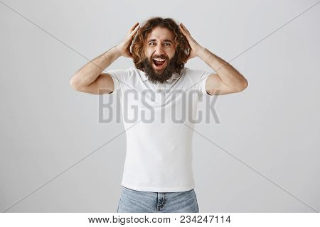 Incredible News Boost Mood. Portrait Of Amazed And Excited Curly-haired Eastern Man With Broad Smile