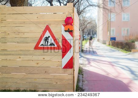 Construction Site Marking Warning  On Sidewalk Cyclist In Distance