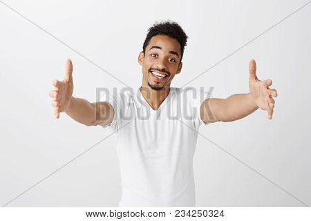 Free Hugs For Person Who Had Bad Day. Cheerfull Kind Dark-skinned Male Model In White T-shirt, Pulli