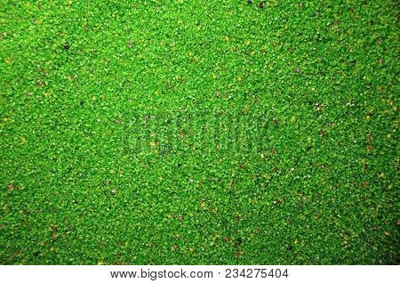 Texture Of A Colored Granular Sand Close Up. Green Grains