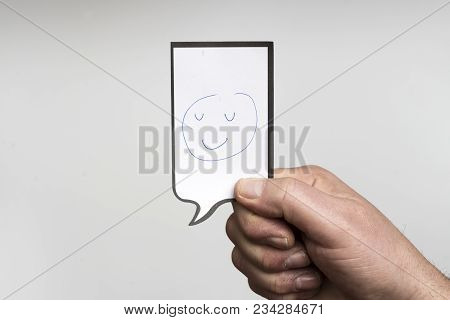 A Small Piece Of Paper With A Drawing Of A Smiling Face