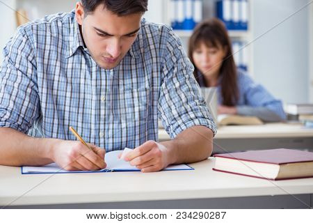 Students sitting and studying in classroom college