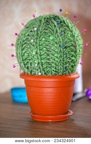 Cactus As A Handmade Needle Bed On A Brown Background