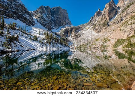 Emerald Lake and reflection with rocks and mountains in snow around at autumn. Rocky Mountain National Park in Colorado, USA. 