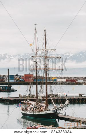 Husavik, Iceland - 20 July, 2016: Yacht In Harbour And Beautiful Snow-covered Mountains On Horizon I