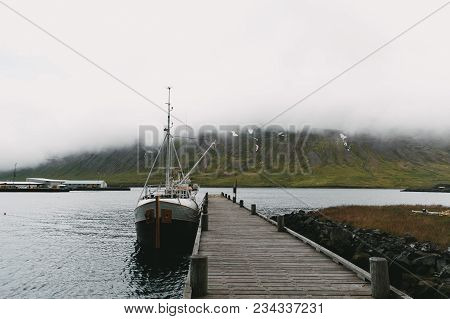 Husavik, Iceland - 20 July, 2016: Yacht Near Wooden Pier In Beautiful Harbour, Husavik, Iceland