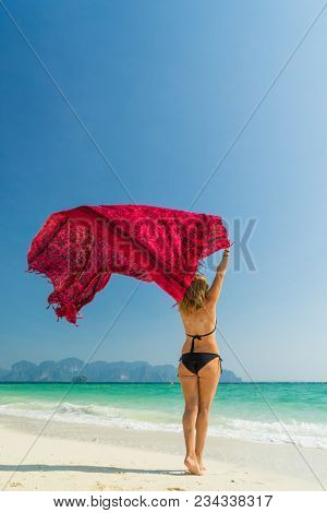 Woman with pink sarong on the tropical beach, Luxury beach travel vacation 