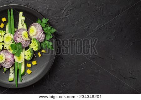 Fresh Vegetables On A Black Plate On A Dark Table