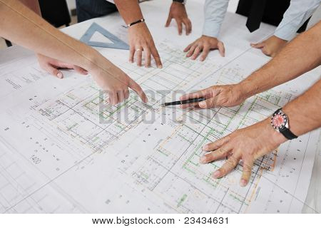 Tiimin arkkitehtien ryhmä construciton päällä tarkistaa asiakirjoja ja business workflow