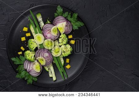 Fresh Vegetables On A Black Plate On A Dark Table