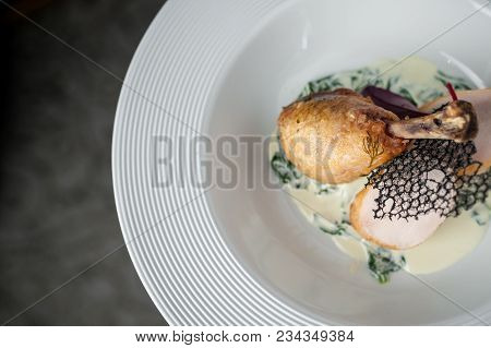 The Main Meat Dish On A Large Deep Plate. Restaurant. Gray Background, Dark Background, Parquet In T