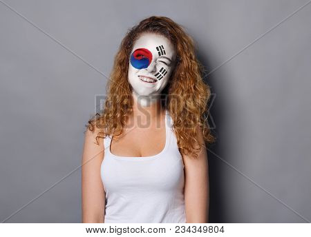 Portrait Of A Woman With The Flag Of Korea Painted On Her Face. Football Or Soccer Team Fan, Sport E