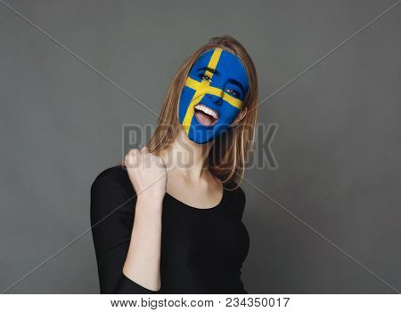 Portrait Of A Woman With The Flag Of Sweden Painted On Her Face. Football Or Soccer Team Fan, Sport 