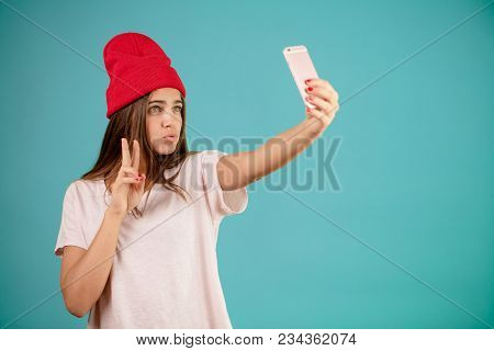 Close Up Portrait Of Young Woman With Inflated Lips Taking Selfies. Like Selfie