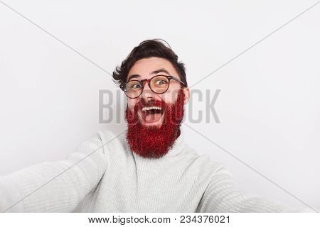 Young Handsome Man With Red Glittering Beard Posing Crazily On White Background.