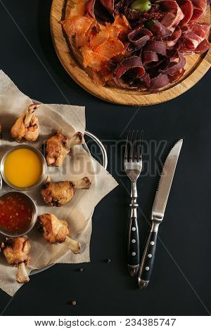 Delicious Roasted Chicken With Various Sauces, Gourmet Assorted Meat And Fork With Knife On Black