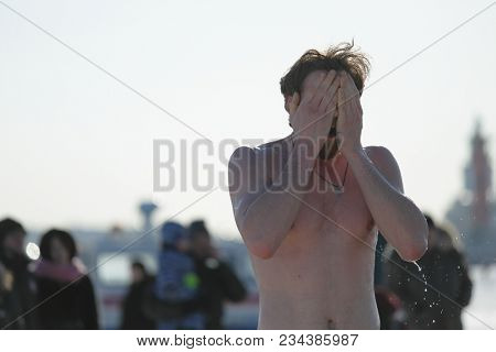 ST. PETERSBURG, RUSSIA - MARCH 4, 2018: Amateur winter swimmer at ice hole during Big Neva Cup. Winter swimmers from 12 countries aged from 12 to 78 take part in the competitions this year