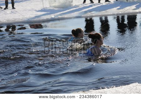 ST. PETERSBURG, RUSSIA - MARCH 4, 2018: Amateur winter swimmer at ice hole during Big Neva Cup. Winter swimmers from 12 countries aged from 12 to 78 take part in the competitions this year