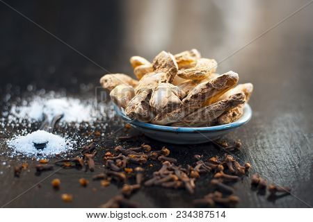 Close Up Of Ayurvedic Herb Or Folk Medicine Dried Ginger Or Zingiber Officinale With Black Pepper Co