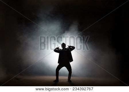 Young Rapper Dancing Isolated On Black Background