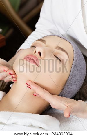 Beautiful Girl Doing Face Massage At The Spa Salon