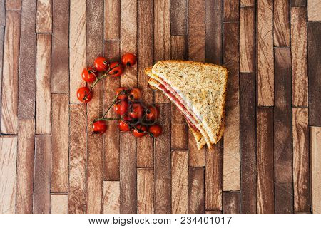 Wholemeal bread sandwich topped with Lyon rosette and butter