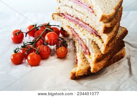 Wholemeal bread sandwich topped with Lyon rosette and butter