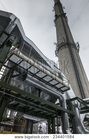 High, Concrete Industrial Chimney And Dust Collector On A Foggy Winter Day