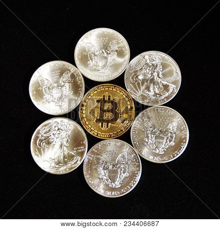 Bitcoin And U.s. Silver Eagle Dollars In A Pile.