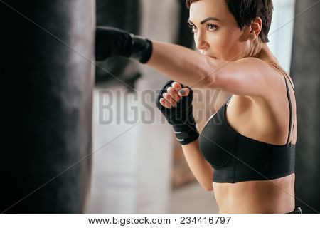 Close Up Cropped Image Of Serious Plucky Athlete Developing Kickboxing Skills. Violent Sport . Reduc