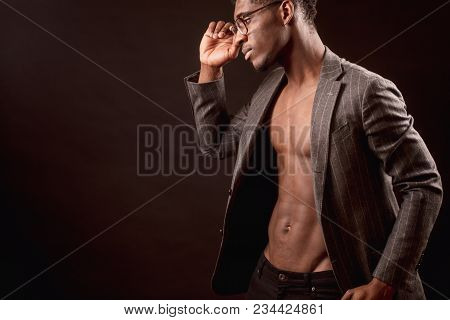 Side View Cropped Photo Of Afro Male Model With Nacked Torso And Suit Jacket Wearing Glasses