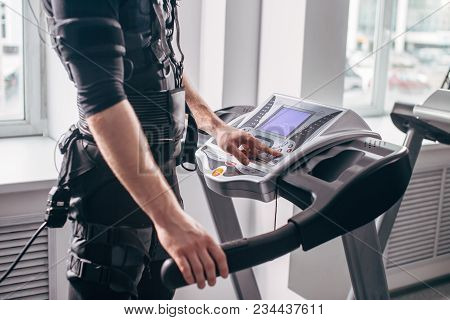 Fit Man In Black Suit For Ems Training Preparing For Running On Treadmill At Gym