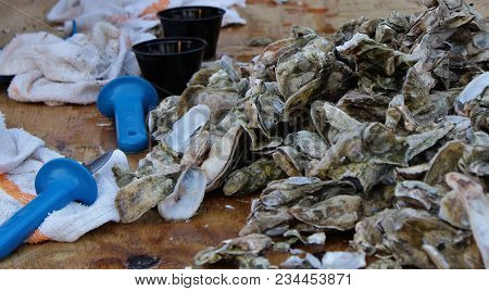Horizontal Oyster Roast Table With Knives And Towels
