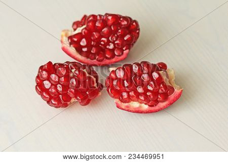 Big Ripe Red Granets Or Garnets. Fruits Of Red Ripe Pomegranate On The White Background. Vegetarian 