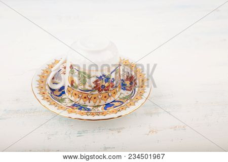 Upside Down Vintage Turkish Coffee Cup Over Saucer Traditionally Using For Fortune Telling On Wooden