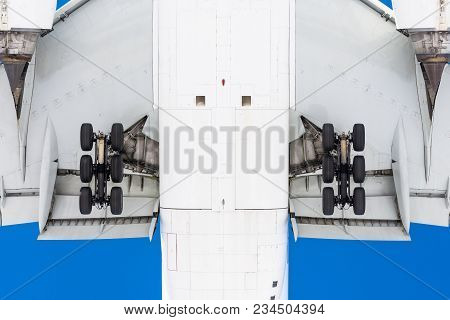 View From Below Under The Flying Airplane Before Landing, In Detail Chassis, Wings, Flaps, Fuselage 