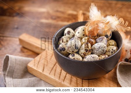 Quail Eggs In Ceramic Mug, Napkin, Wooden Board On Wooden Table. Quail Eggs Similar In Color With A 