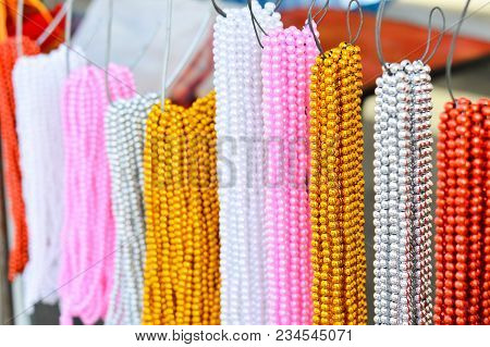 Colorful Multicolor Beaded And Artificial Pearl Necklace Hang On A Steel Hook To Sell On Street Mark
