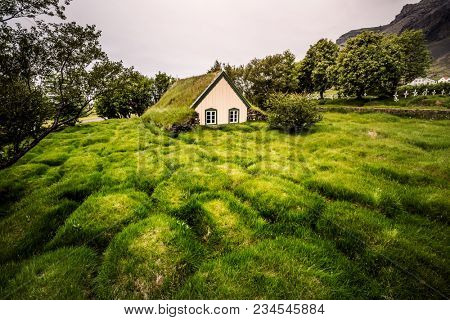 Amazing view of turf church Hofskirkja. Location place of Iceland, small village Hof, Europe. Scenic image of beautiful nature landscape. Attractive summer scene. Discover the beauty of earth.