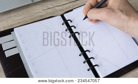 Man Is Going To Write Something On His Notebook. Top View, Flat Lay. In Search Of Inspiration. A Man