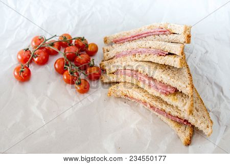 Wholemeal bread sandwich topped with Lyon rosette and butter