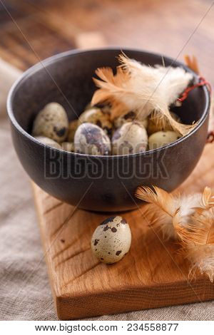Quail Eggs In Ceramic Mug, Napkin, Wooden Board On Wooden Table. Quail Eggs Similar In Color With A 