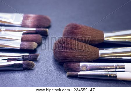 A Set Of Profeccional Make Up Brushes On A Dark Background, Close Up