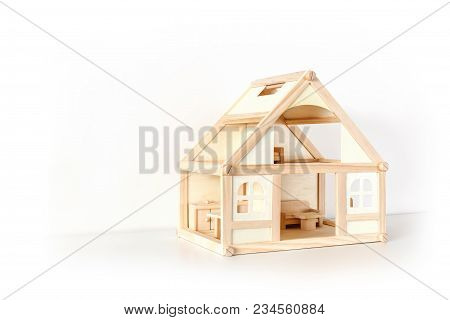 Wooden House Model With Furniture On White Surface. Facade View. Isolated On White. Real Estate. Sal