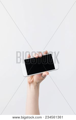 Cropped Shot Of Woman Holding Smartphone With Lank Screen Isolated On White