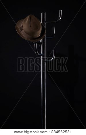 Classic Hat On Coat Rack Isolated On Black