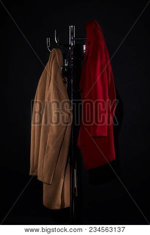 Classic Coats On Coat Rack Isolated On Black