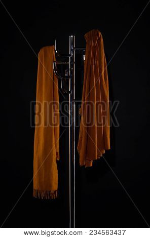 Two Scarves On Coat Rack Isolated On Black
