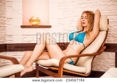 Beautiful Girl Sit On Chair In Spa In Salt Room